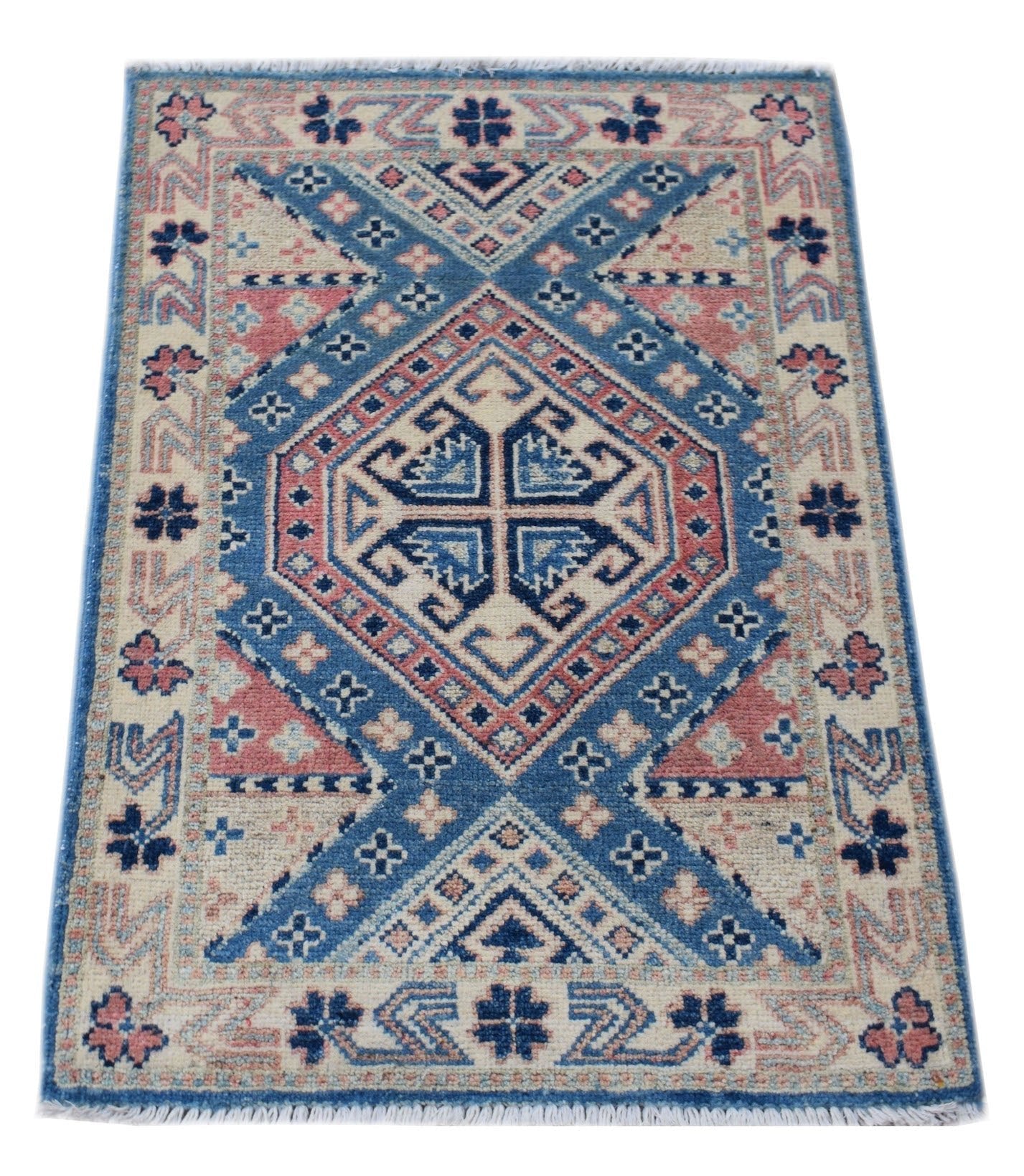 A handmade wool Afghan Kazakh rug featuring a geometric blue and pink diamond pattern.