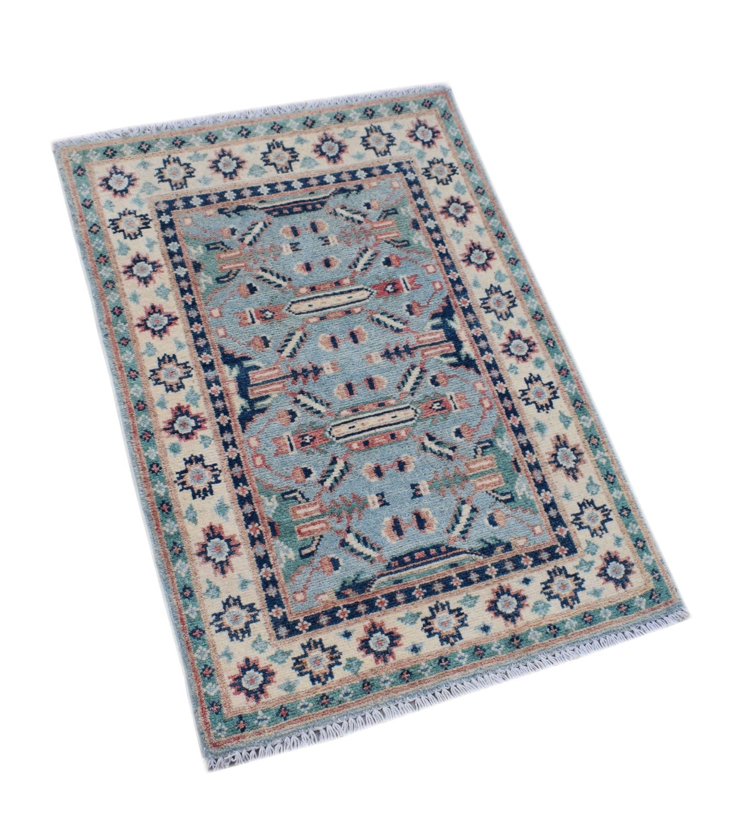 A handmade mini Afghan Kazakh rug featuring a blue field with geometric patterns and fringe ends.