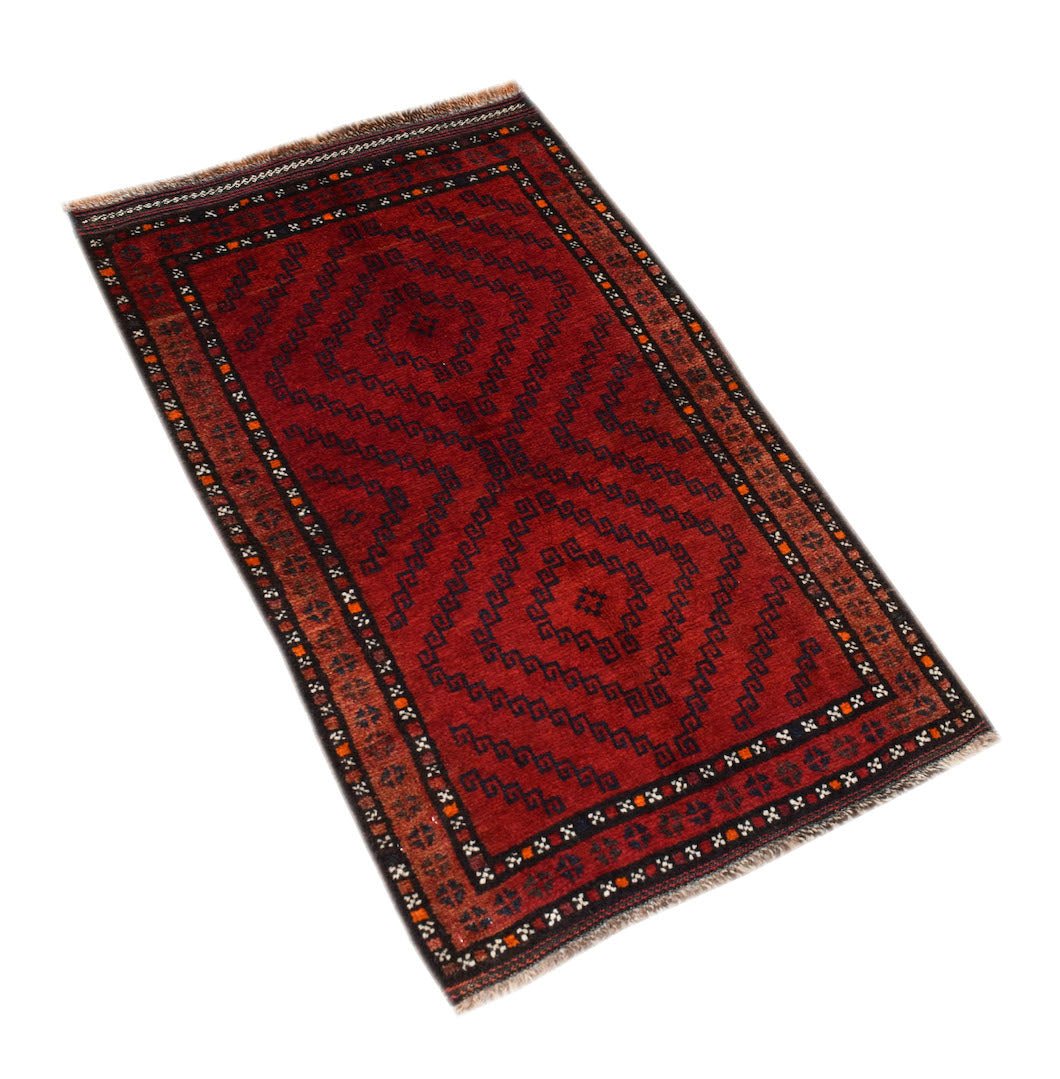 A rectangular vintage Afghan Baluch rug featuring a deep red field with geometric diamond patterns.