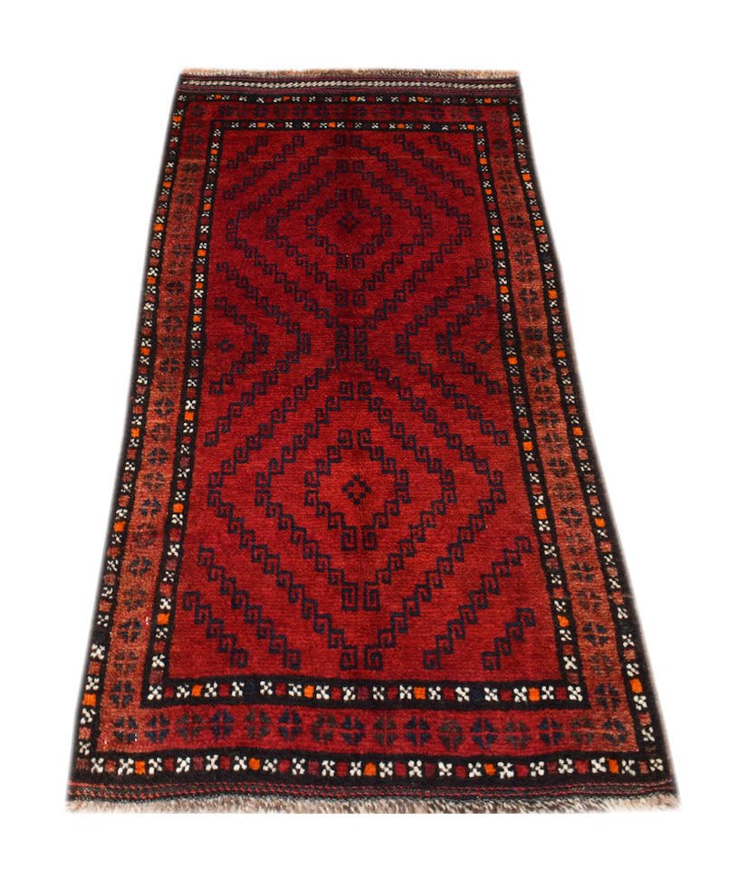 A vintage handmade Afghan Baluch rug featuring a geometric diamond pattern in deep red and black.