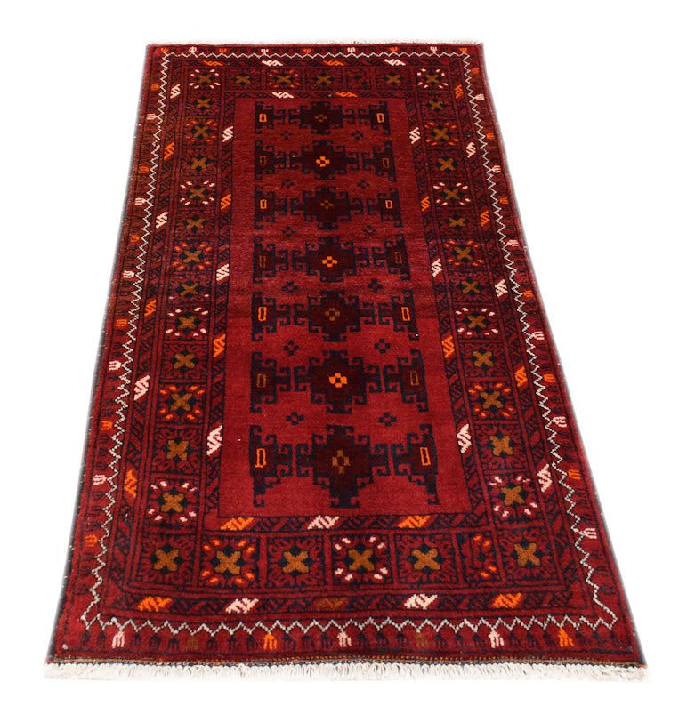 A handmade vintage Afghan Baluch rug featuring dark red tones and geometric tribal patterns.