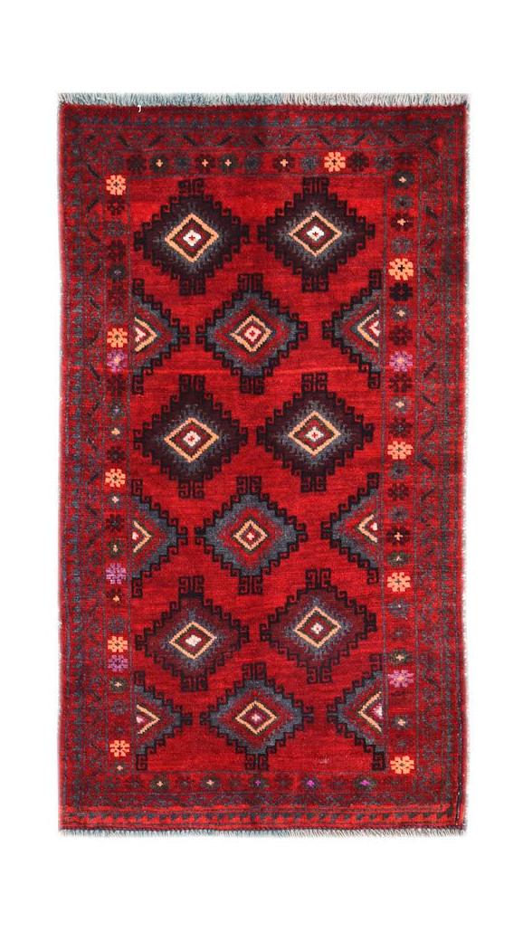 A vintage handmade Afghan Baluch rug featuring geometric diamond patterns on a deep red background.