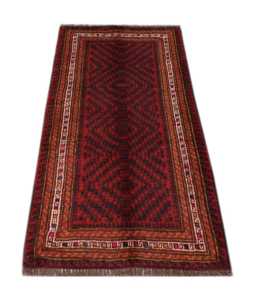 A handmade vintage Afghan Baluch rug featuring a dark red geometric pattern and fringed ends.