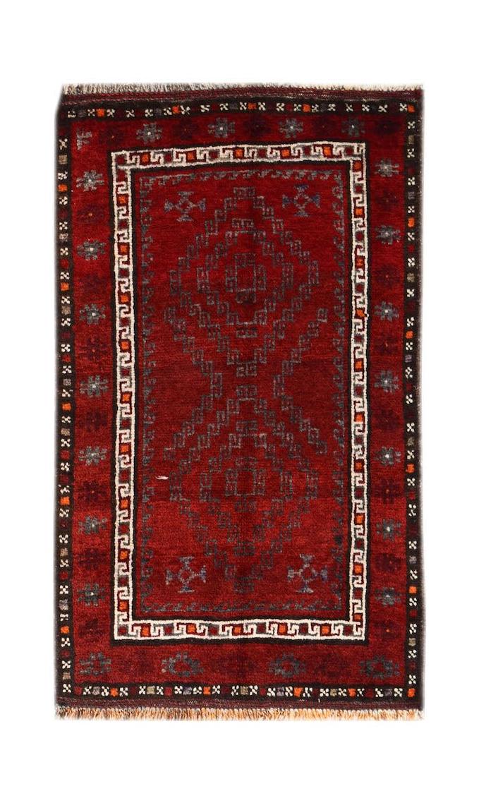 A vintage handmade Afghan Baluch rug featuring a deep red field with geometric tribal patterns.