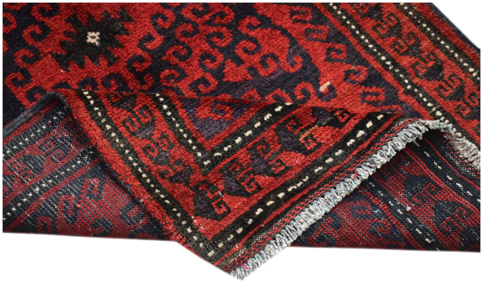 A vintage handmade Afghan Baluch wool rug featuring a geometric pattern in red and dark blue.
