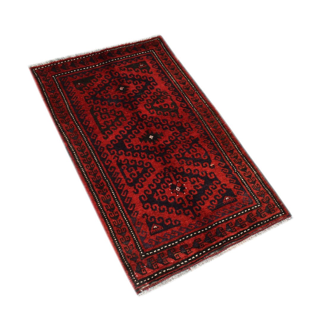 A vintage handmade Afghan Baluch rug featuring a geometric pattern in deep red and black tones.