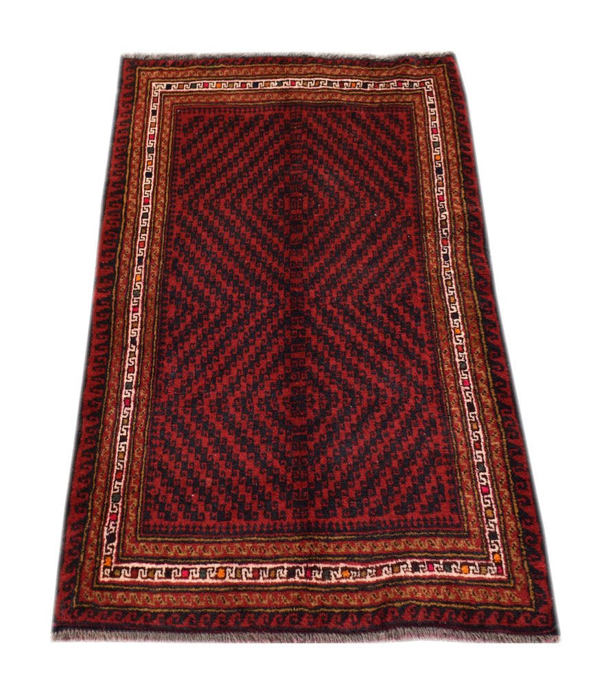 A handmade vintage Afghan Baluch rug featuring a dark red and black geometric diamond pattern.
