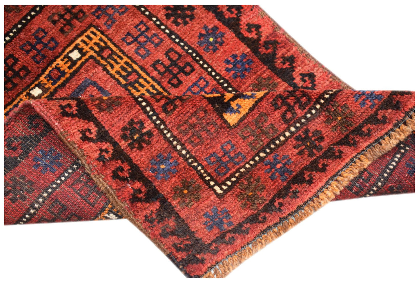 A vintage handmade Afghan Baluch wool rug featuring traditional geometric patterns in red and blue.