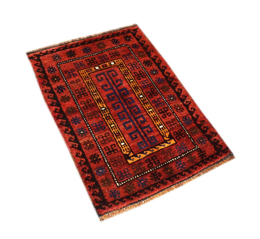 A vintage handmade Afghan Baluch rug featuring a red field with geometric blue and gold patterns.
