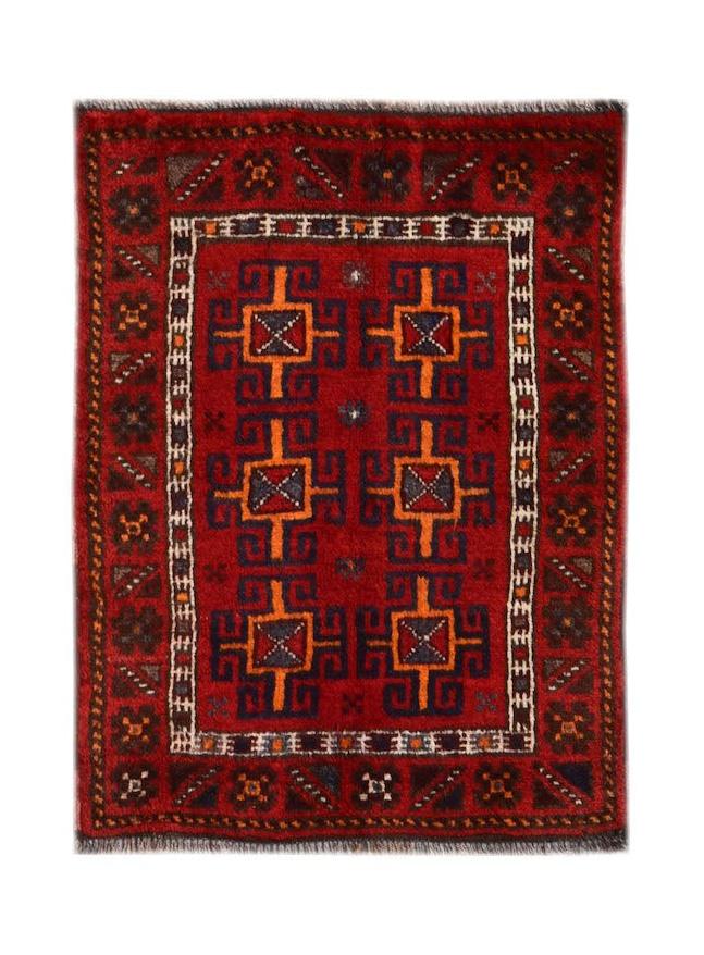 A vintage handmade Afghan Baluch wool rug featuring a red field with geometric tribal motifs.