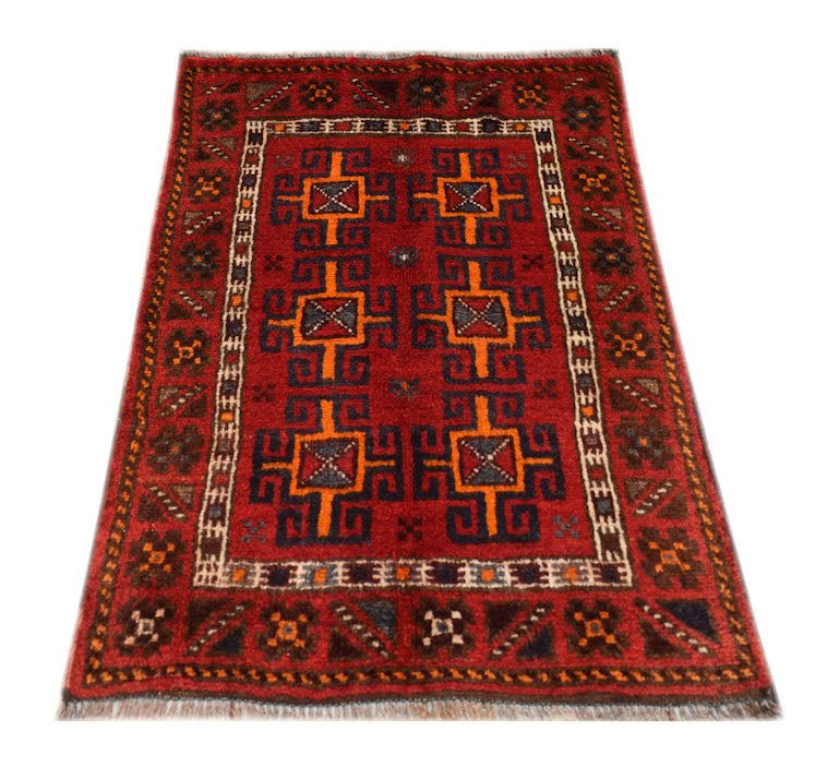 A vintage handmade Afghan Baluch wool rug featuring geometric patterns in red, orange, and blue.