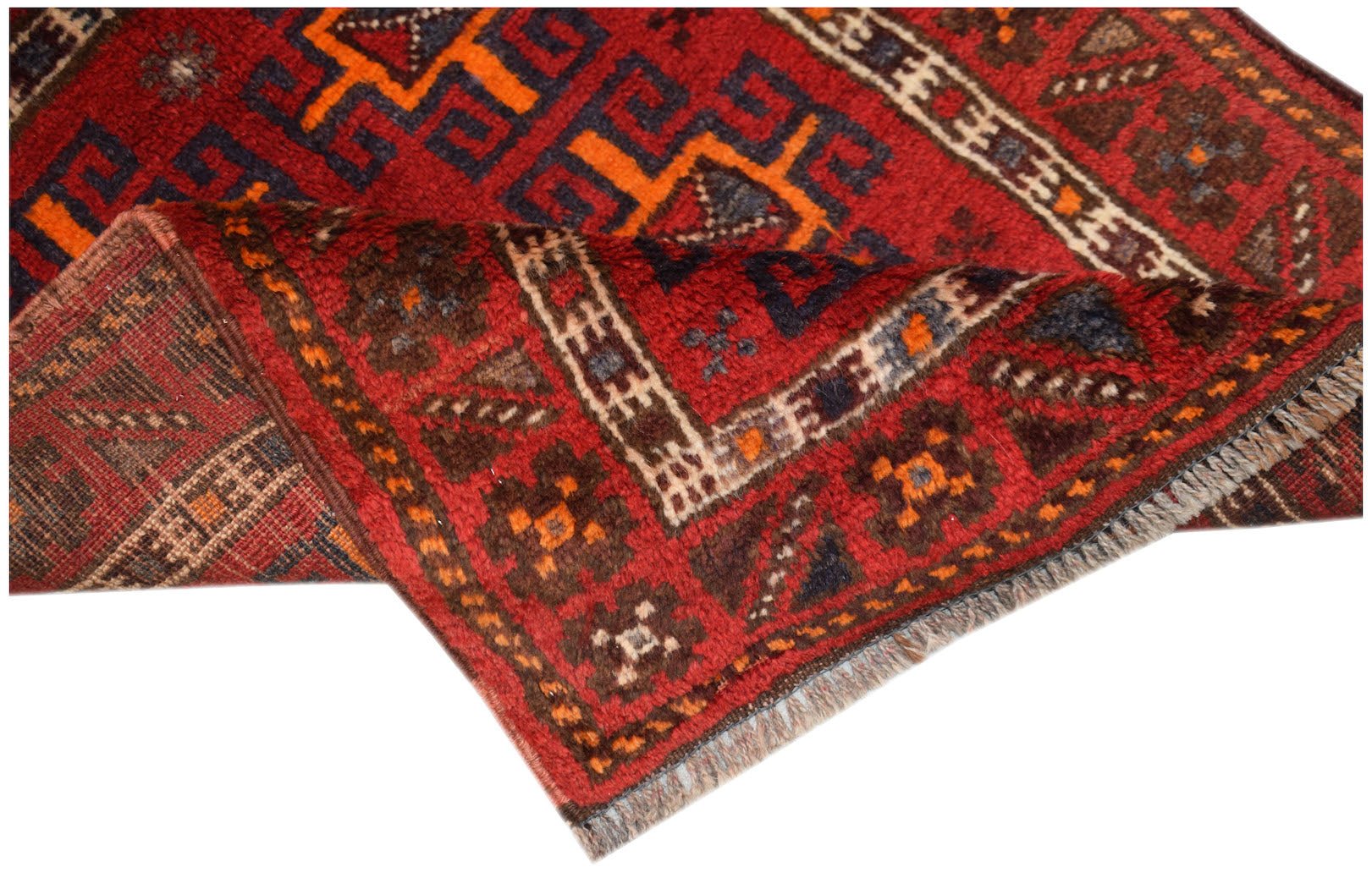A vintage handmade Afghan Baluch wool rug featuring geometric patterns in red, orange, and blue.