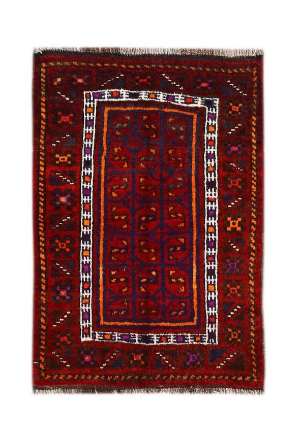 A vintage handmade Afghan Baluch wool rug featuring a deep red field with geometric tribal patterns.