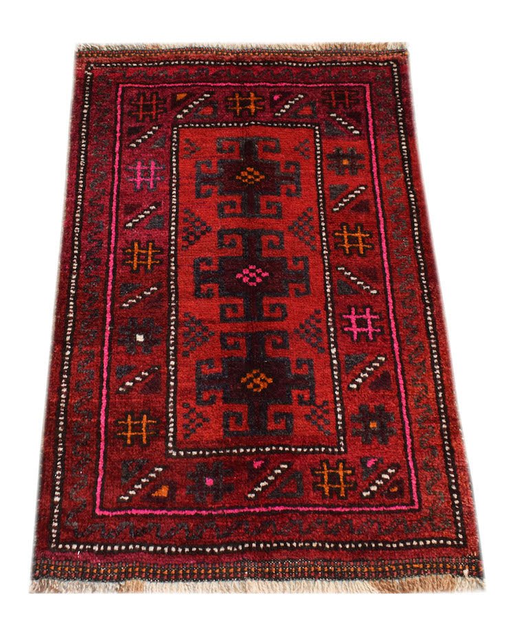 Vintage Afghan Baluch rug with a red background and geometric patterns.
