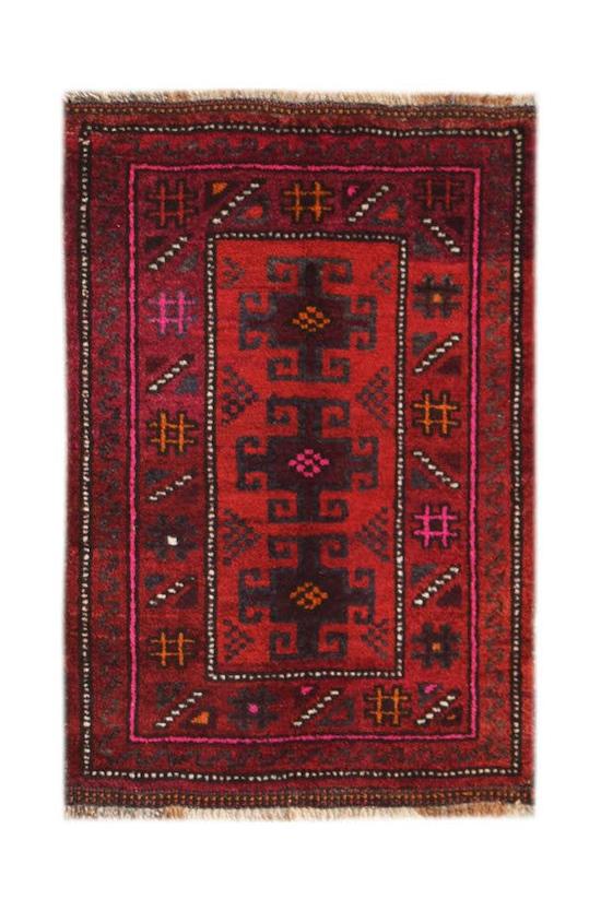 A vintage handmade Afghan Baluch rug featuring dark red tones and geometric tribal patterns.