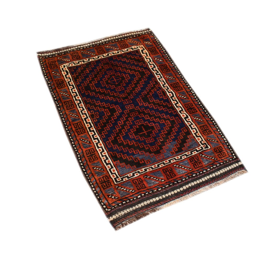 A handmade vintage Afghan Baluch rug featuring geometric diamond patterns in dark blue and red.