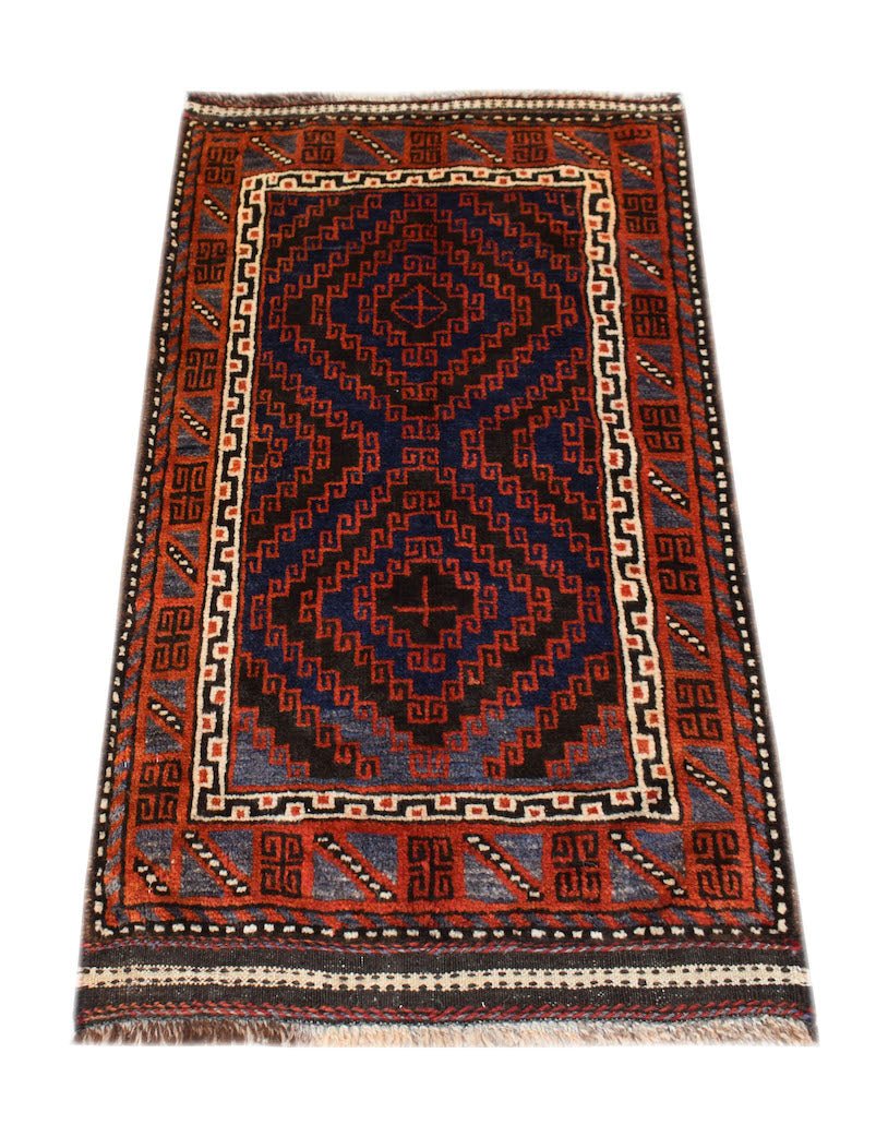 A vintage handmade Afghan Baluch rug featuring geometric diamond patterns in red, blue, and brown.