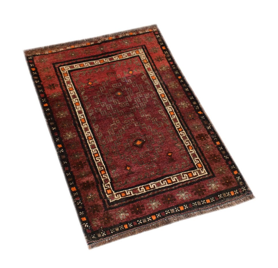 A rectangular handmade Afghan Baluch rug featuring a deep red field with geometric tribal patterns.