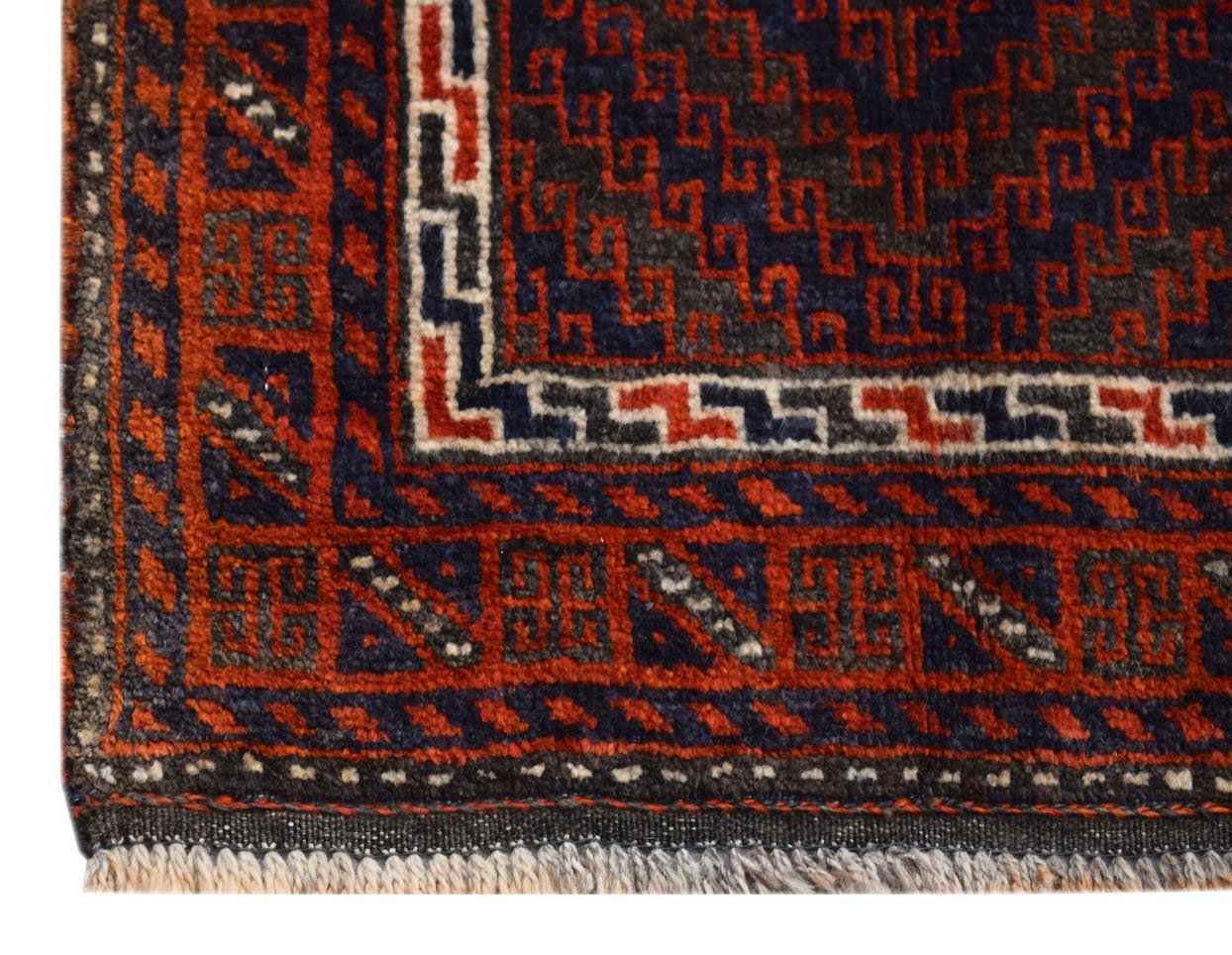 A handmade vintage Afghan Baluch rug featuring geometric patterns in dark red, blue, and ivory.