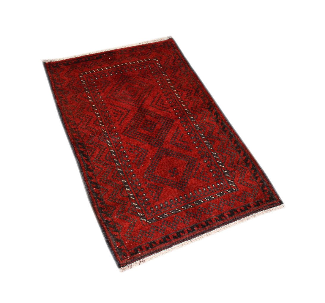 A rectangular vintage Afghan Baluch rug featuring a dark red field with black geometric patterns.