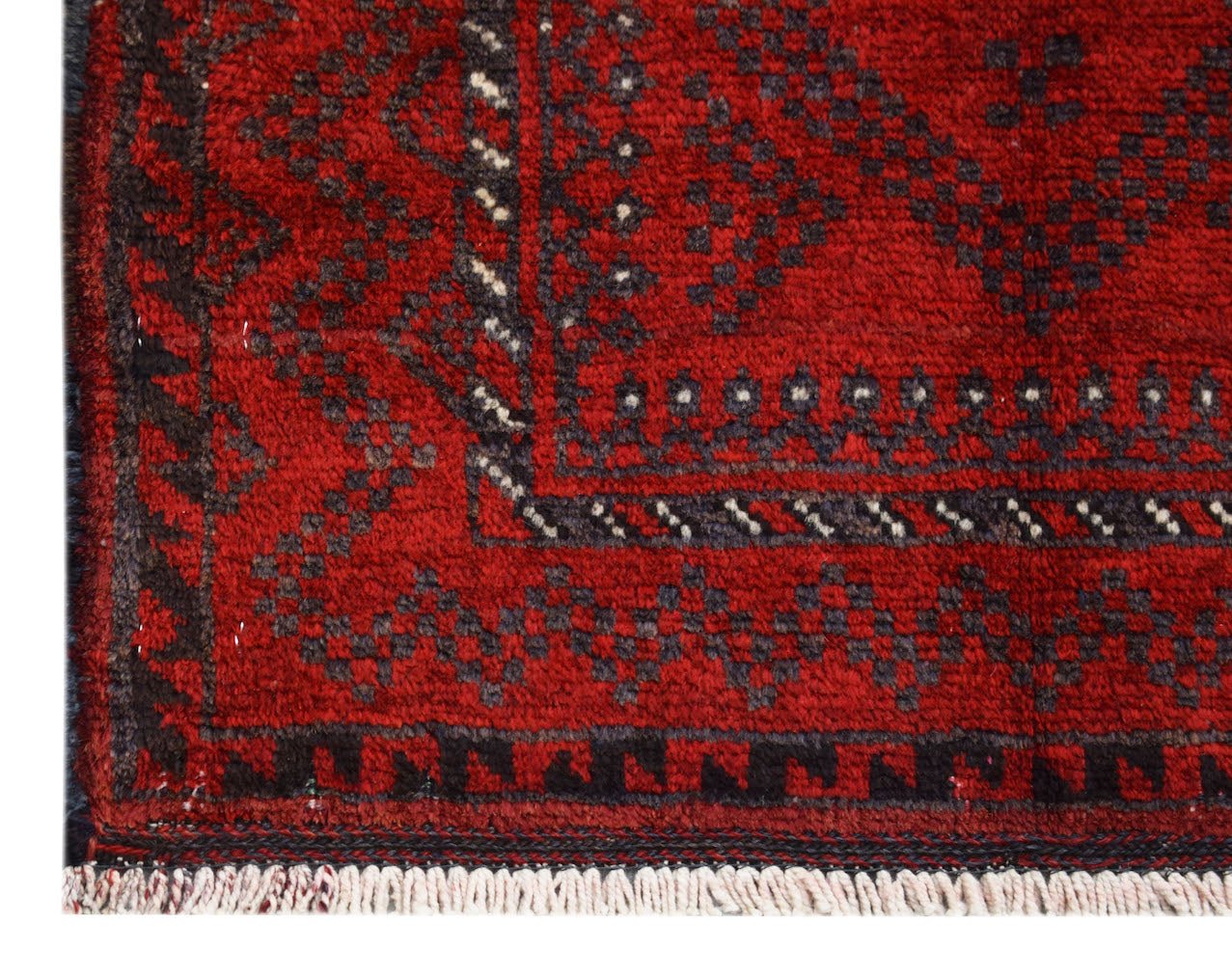 A vintage handmade Afghan Baluch rug featuring a geometric pattern in deep red and dark charcoal.