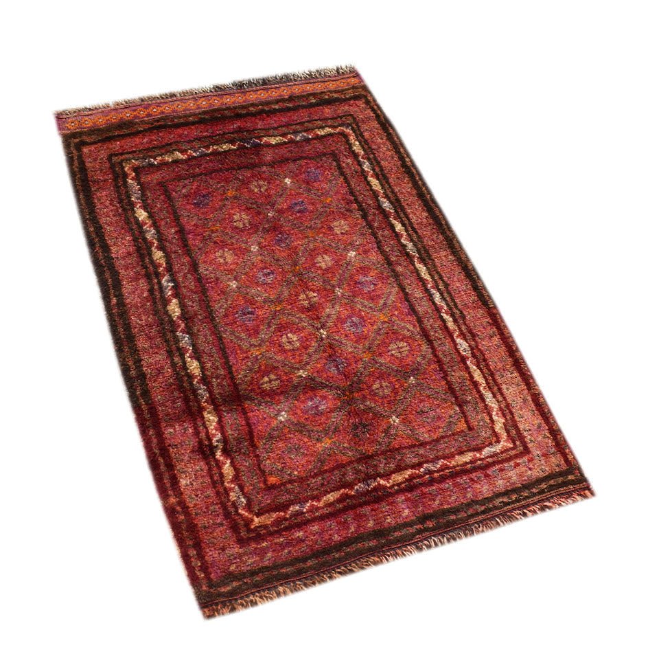 A vintage handmade Afghan Baluch rug featuring a red diamond pattern and fringed edges.