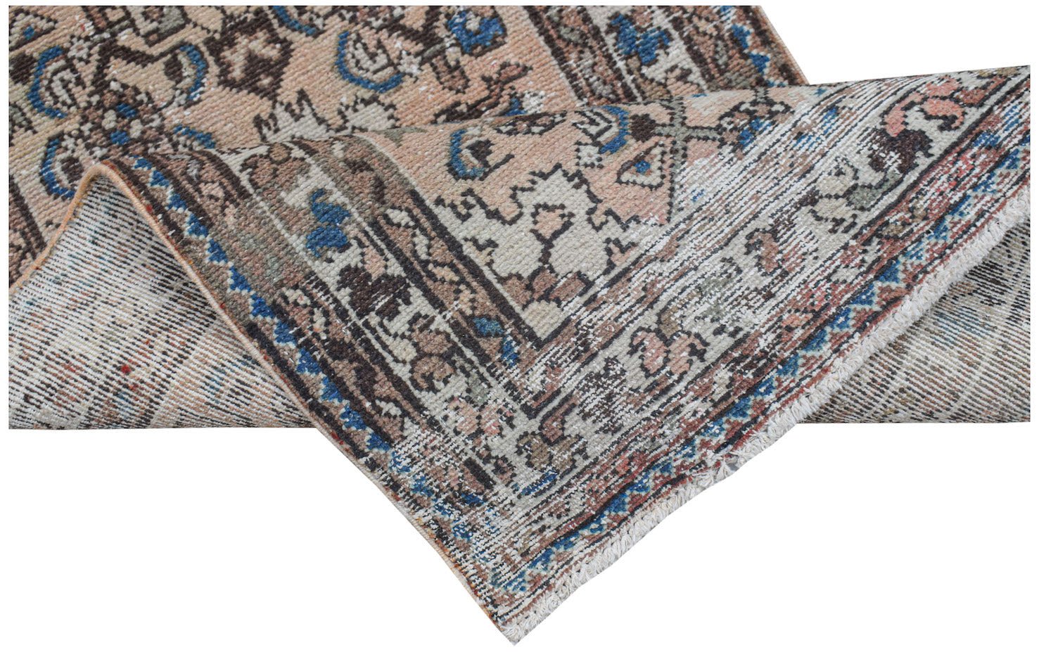A handwoven vintage Persian rug with a faded floral pattern in blue, brown, and cream tones.