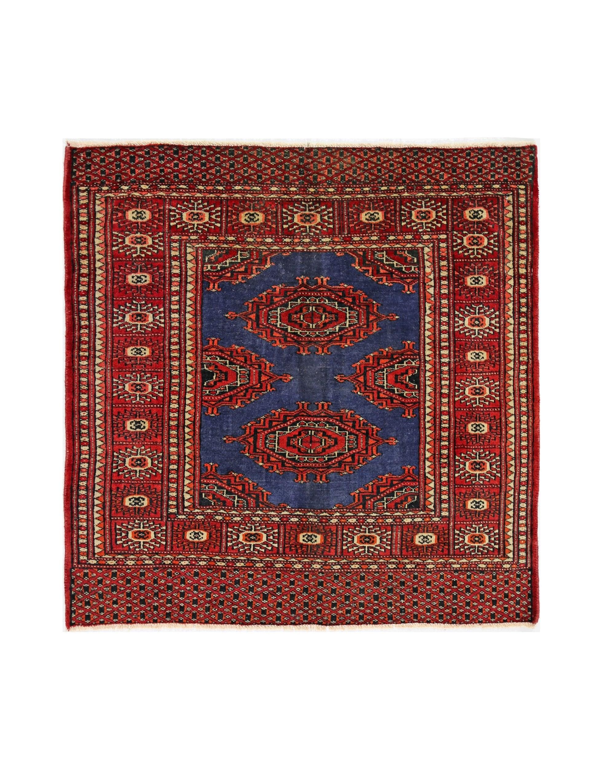 A vintage Pakistani Princess Bokhara rug featuring a blue field with red geometric medallions.