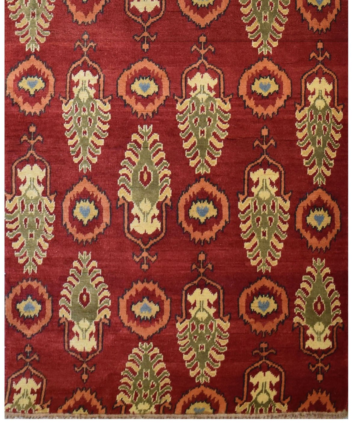 An Afghan Chobi runner rug featuring a repeating pattern of stylized motifs in red and green.