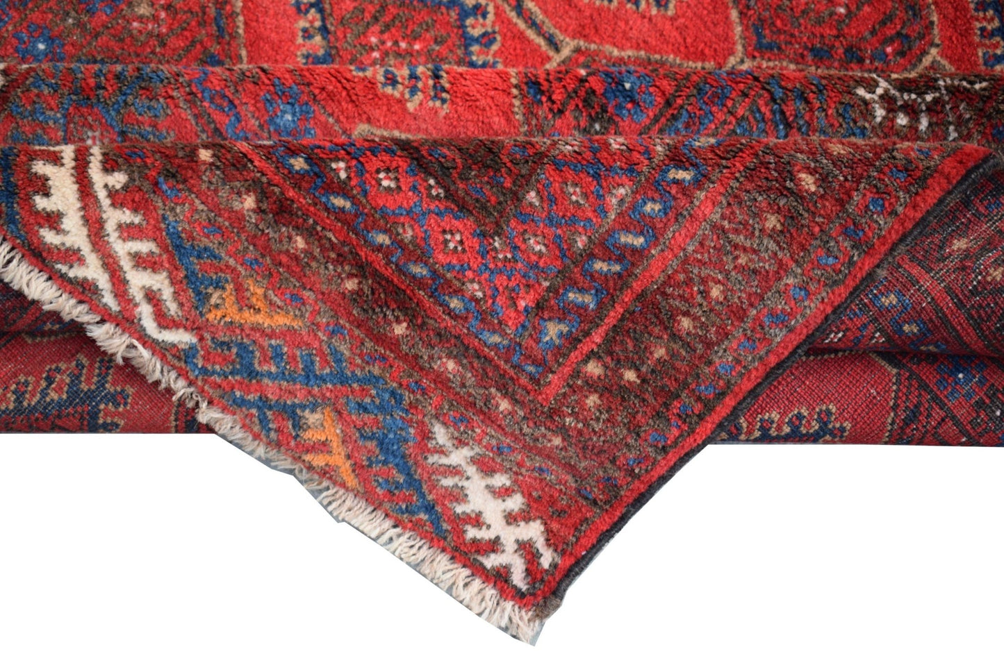 A vintage handmade Afghan Baluch wool rug featuring traditional geometric patterns in red and blue.