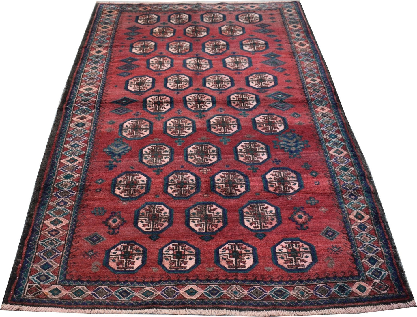 A vintage Afghan Baluch rug featuring a repeating octagonal pattern on a deep red field.
