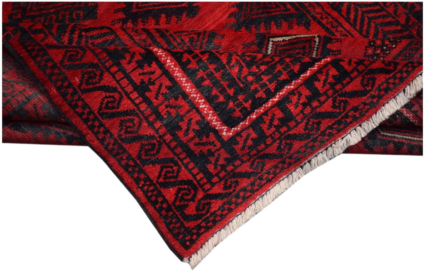 A vintage handmade Afghan Baluch rug featuring a geometric black pattern on a deep red background.