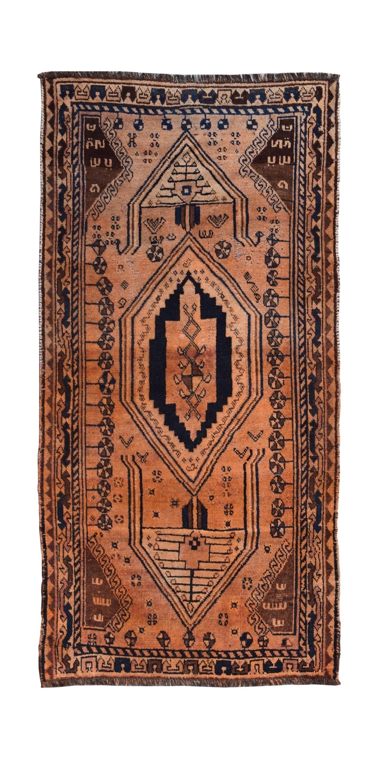A vintage handmade Afghan Baluch rug featuring a central diamond motif in orange and dark blue.