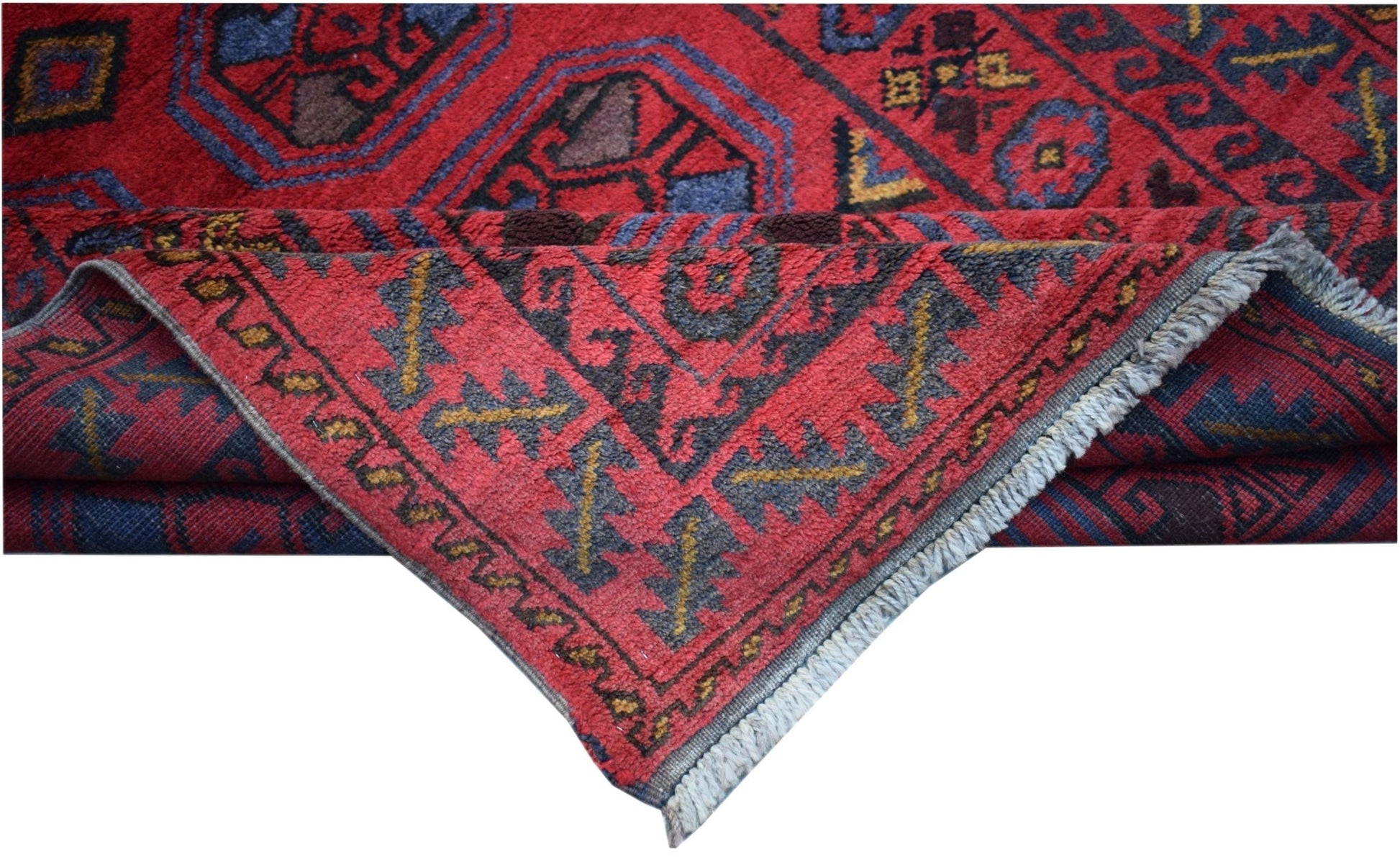 A vintage handmade Afghan Baluch wool rug featuring a red field with geometric tribal patterns.