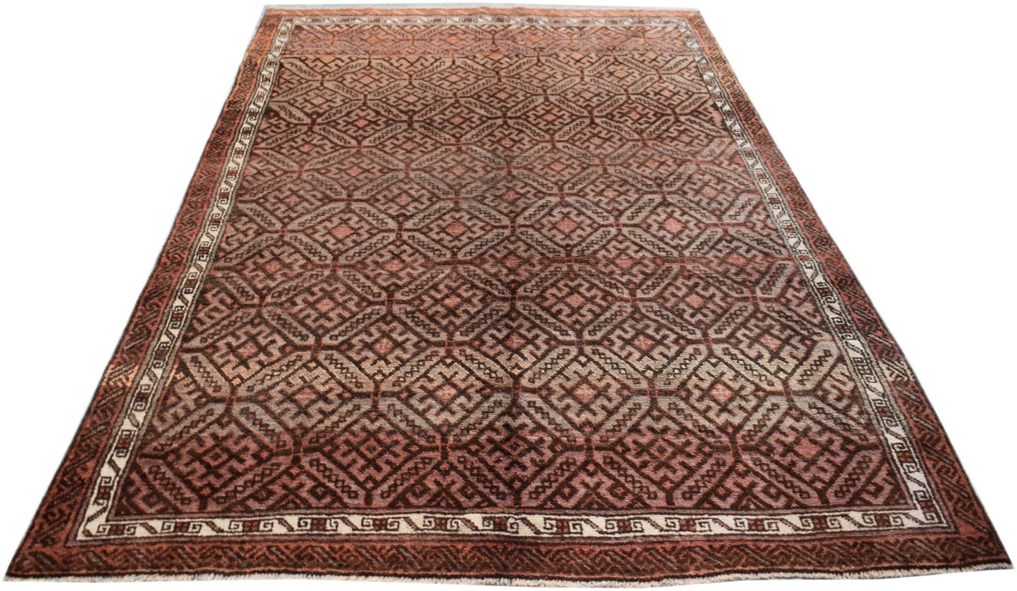 A vintage handmade Afghan Baluch rug featuring a repeating geometric pattern in shades of brown.