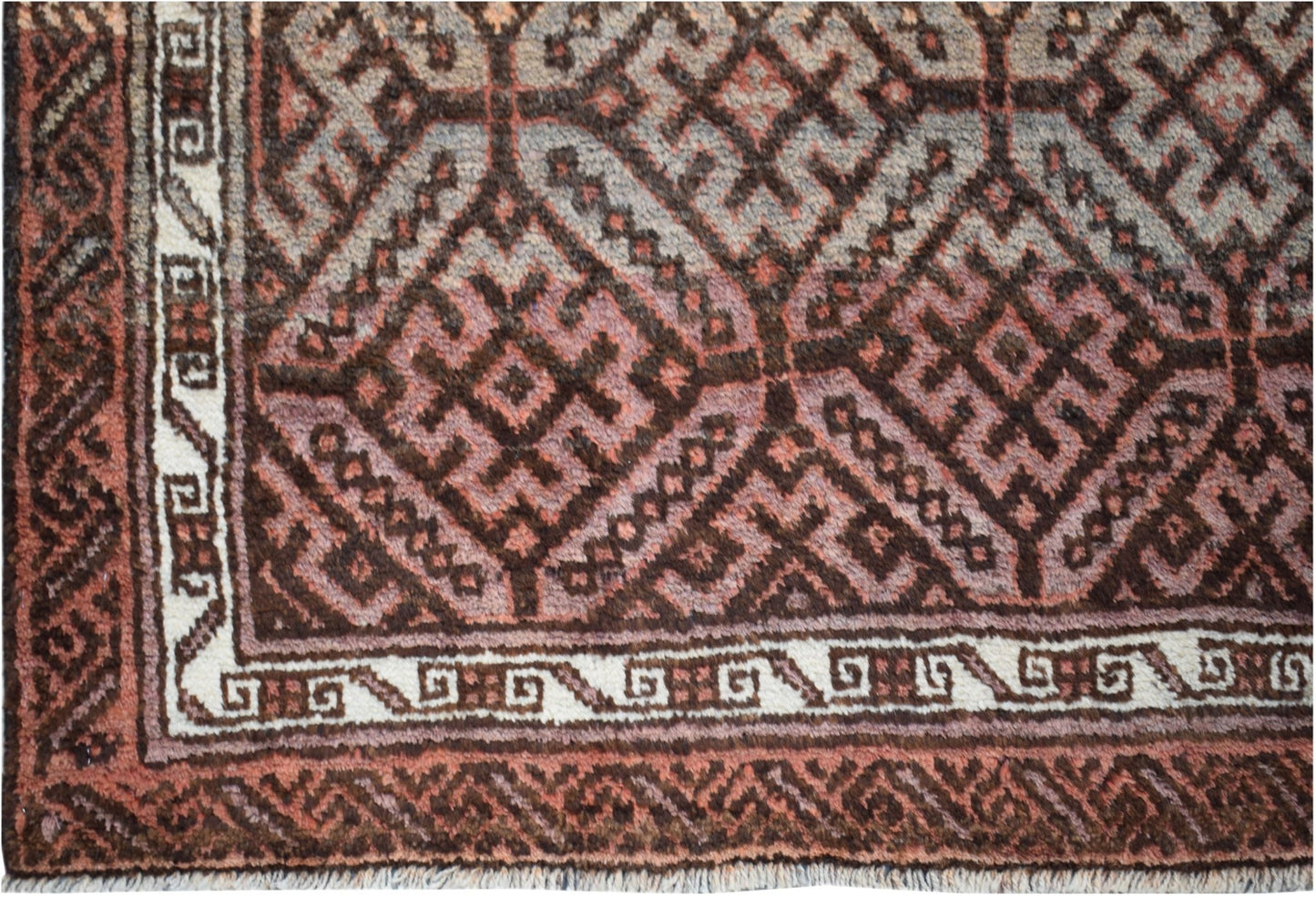 A vintage Afghan Baluch rug featuring a geometric diamond pattern in shades of brown and cream.