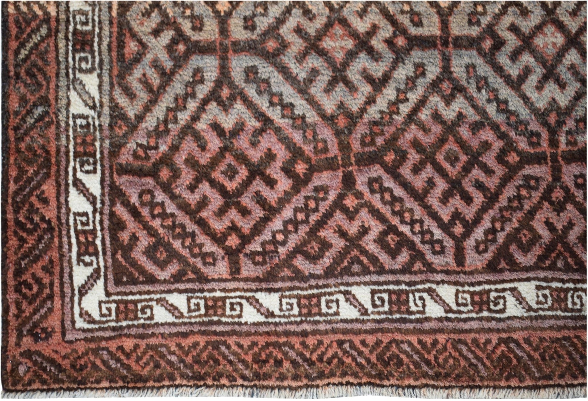 A vintage Afghan Baluch rug featuring a geometric diamond pattern in shades of brown and cream.