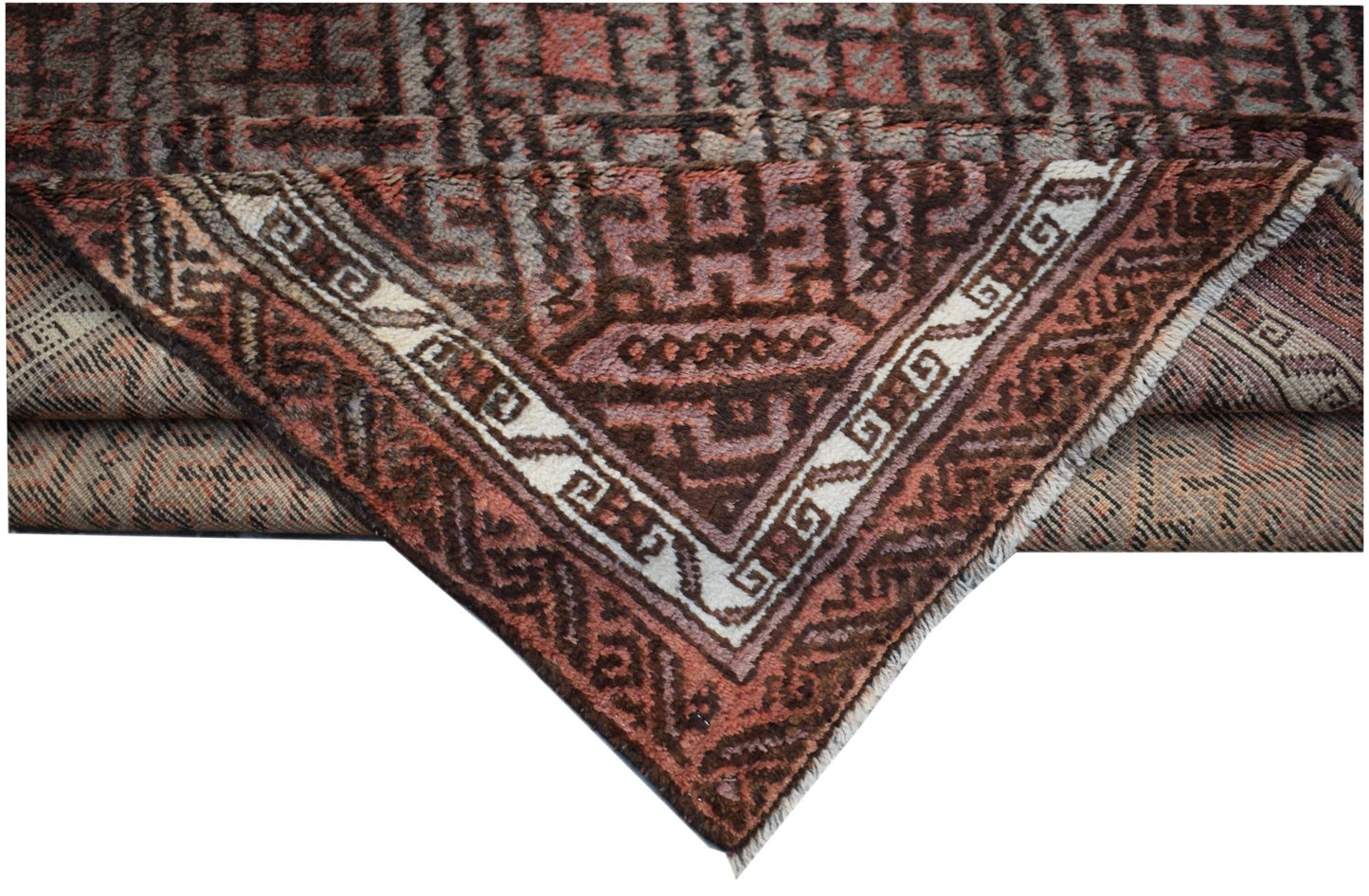 A vintage handmade Afghan Baluch wool rug featuring geometric patterns in brown and muted red.