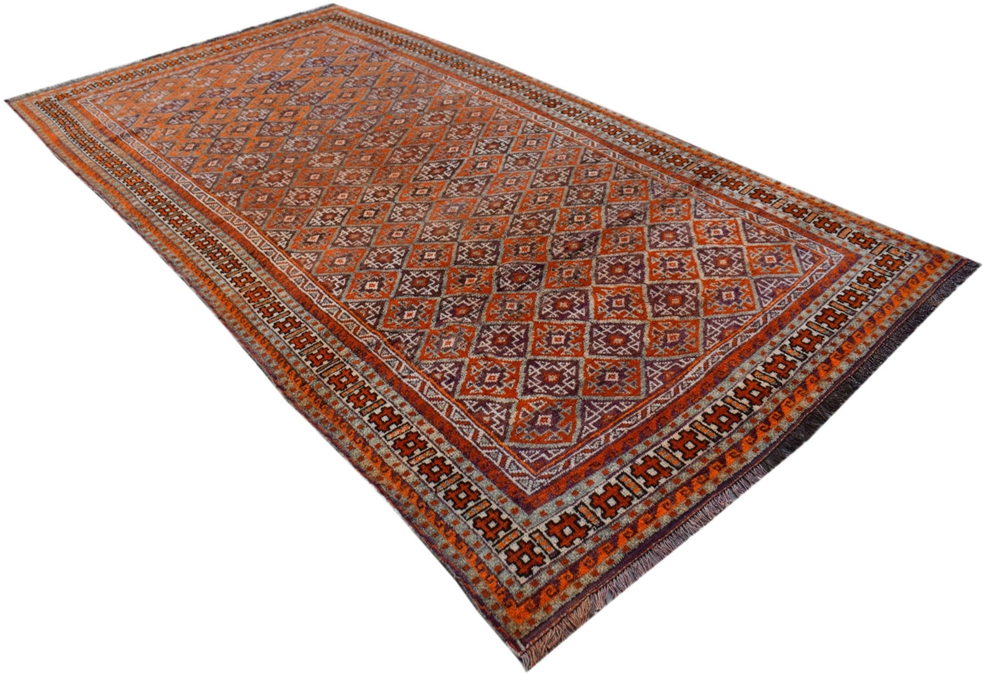 A vintage Afghan Baluch rug featuring a repeating diamond pattern in shades of orange and purple.