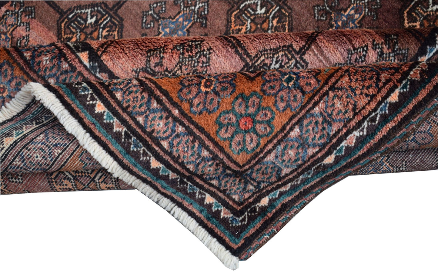 A folded vintage Afghan Baluch wool rug featuring intricate geometric patterns in earthy tones.