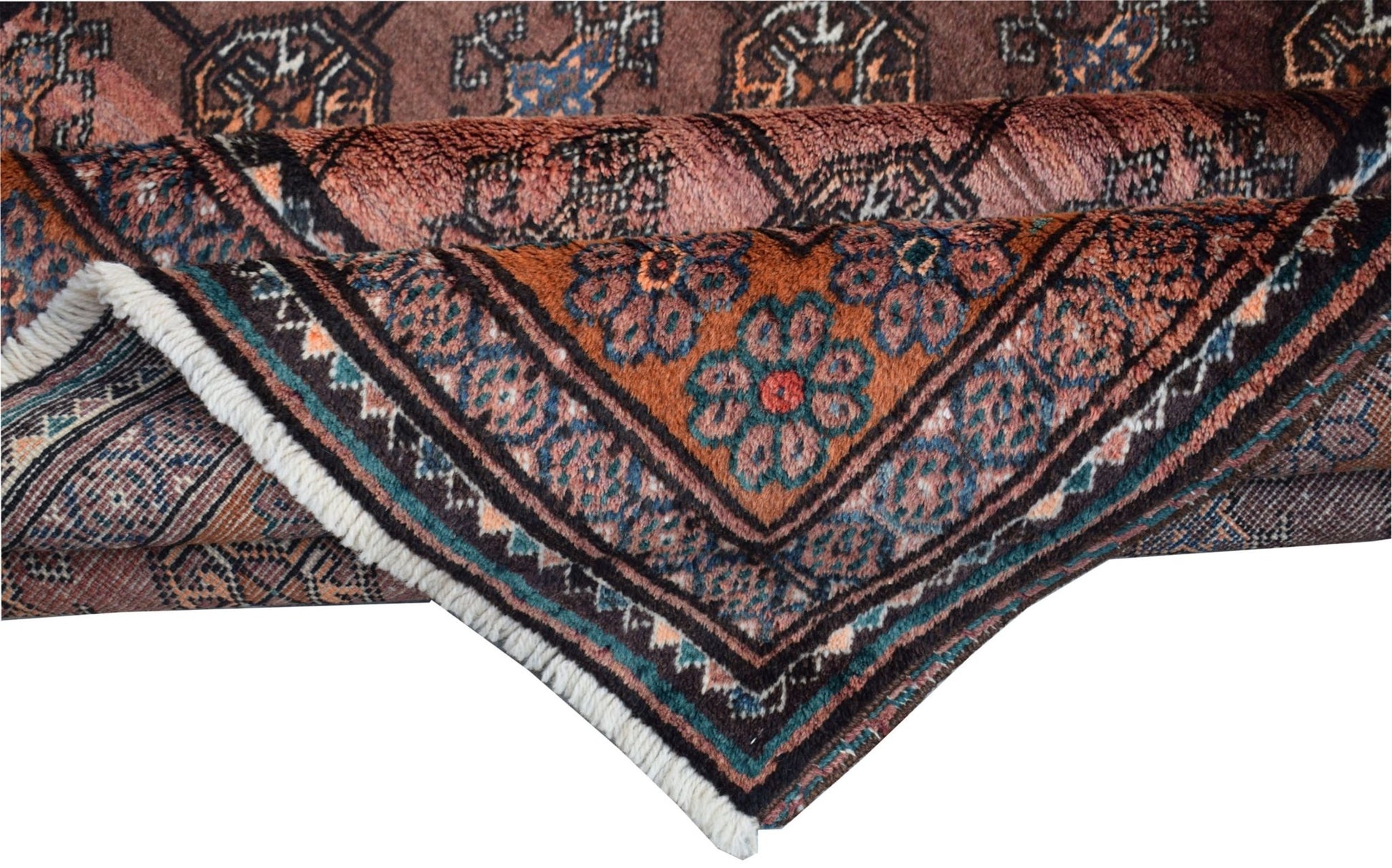 A folded vintage Afghan Baluch wool rug featuring intricate geometric patterns in earthy tones.
