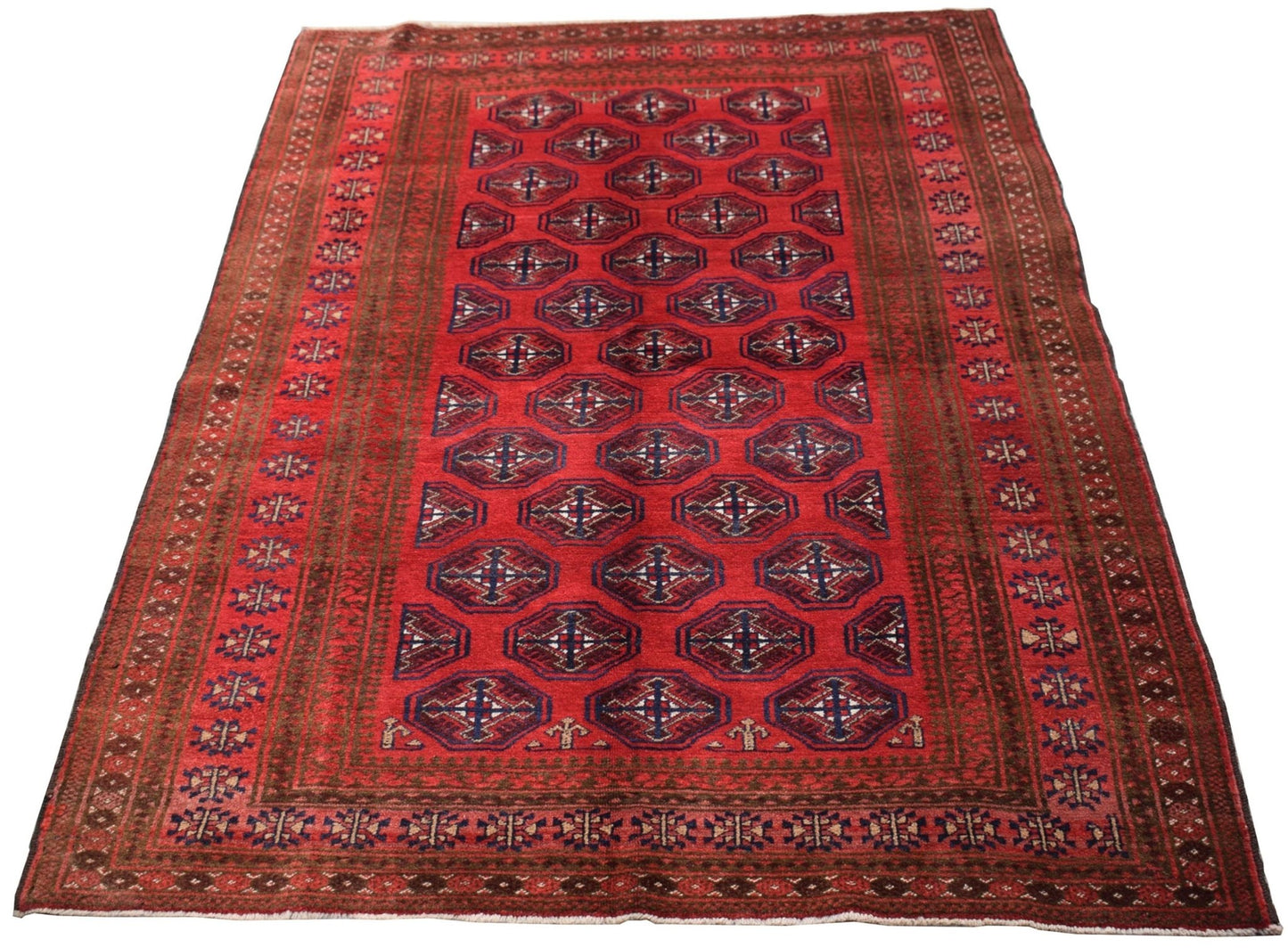 A vintage Afghan Baluch rug featuring a repeating geometric pattern in red, blue, and cream tones.