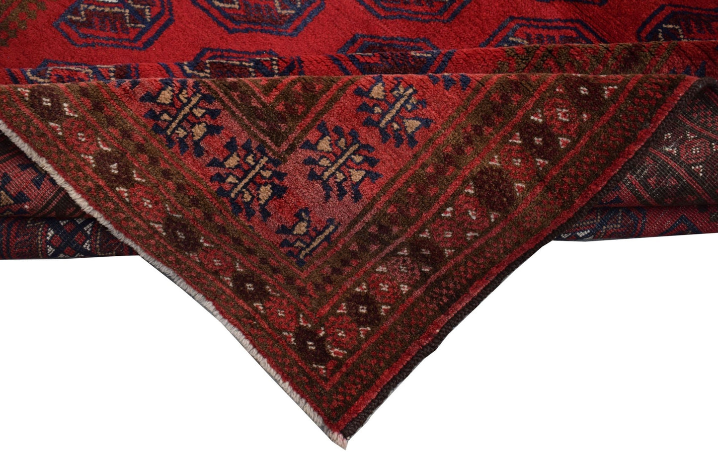 A vintage handmade Afghan Baluch wool rug featuring a red field with geometric tribal patterns.