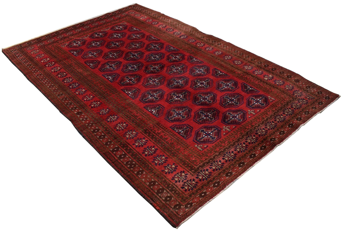 A vintage handmade Afghan Baluch rug featuring a repeating octagonal pattern in deep red tones.