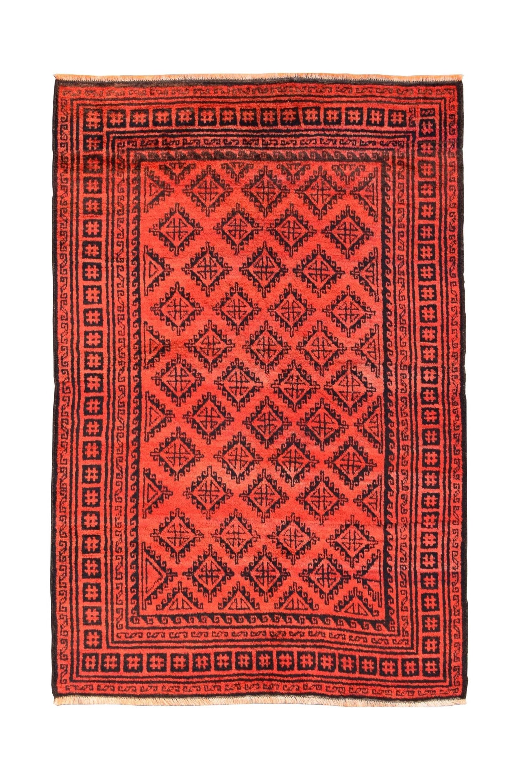 A vintage handmade Afghan Baluch rug featuring a red field with black geometric diamond patterns.