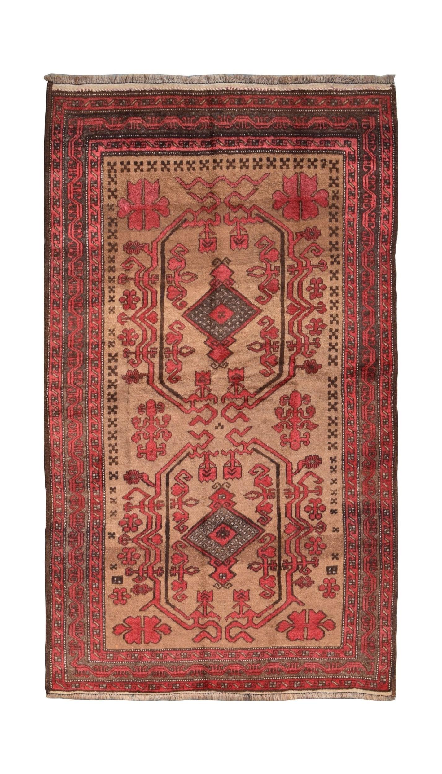 A vintage handmade Afghan Baluch wool rug featuring geometric red patterns on a tan background.