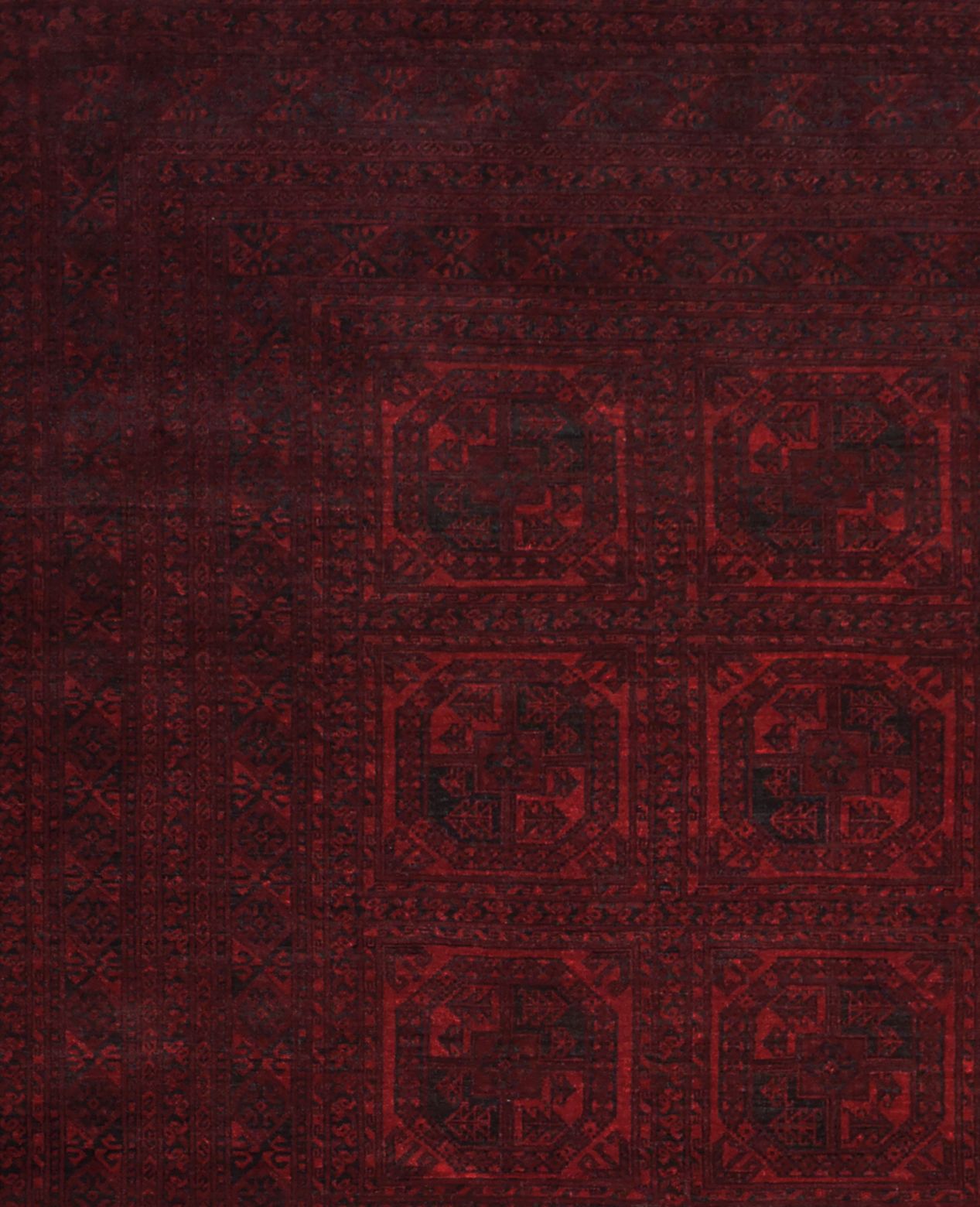 A vintage handmade Afghan Turkmen rug featuring a deep red geometric pattern.
