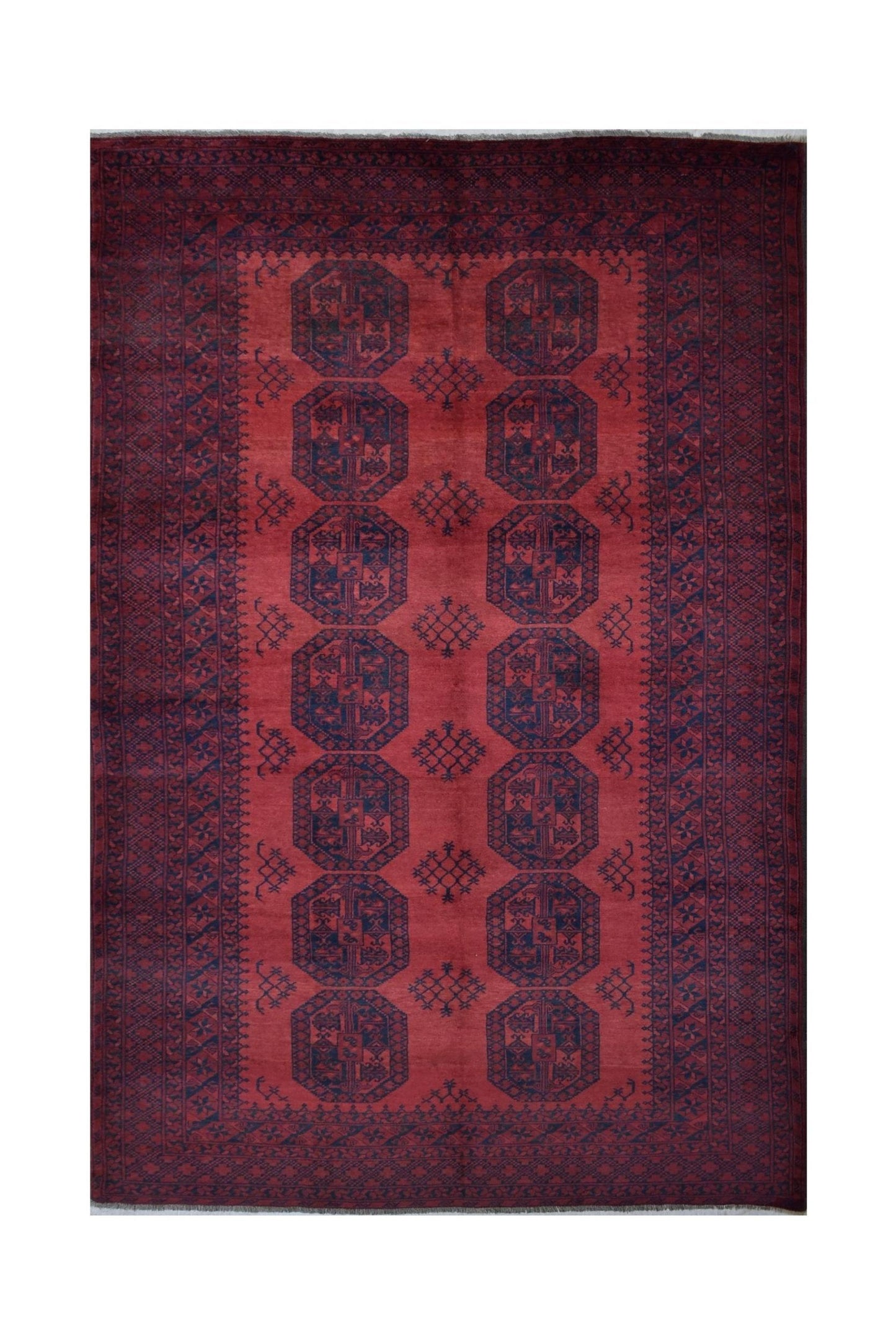A vintage handmade Afghan Turkmen rug featuring a deep red field with repeating dark octagonal motifs.