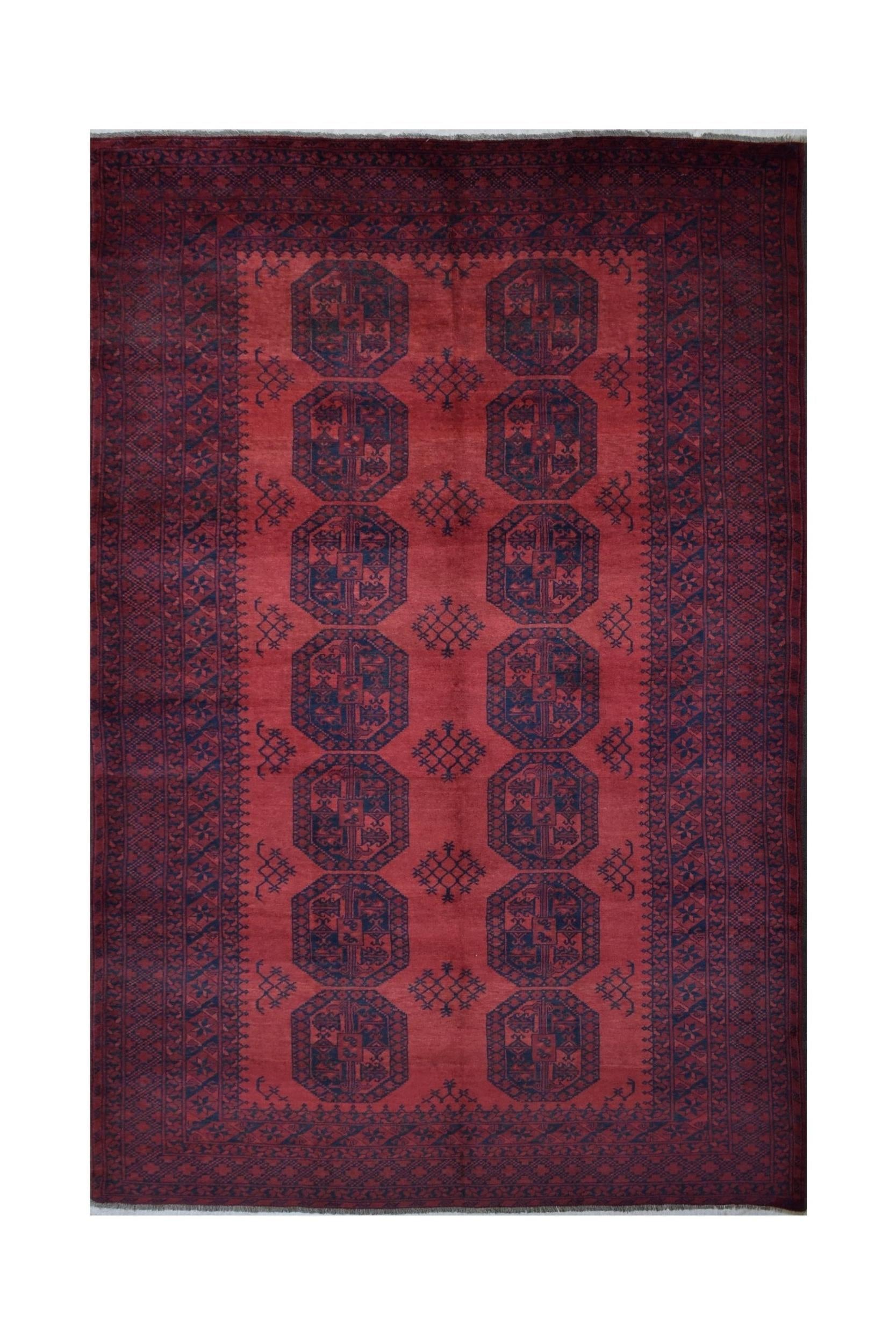 A vintage handmade Afghan Turkmen rug featuring a deep red field with repeating dark octagonal motifs.
