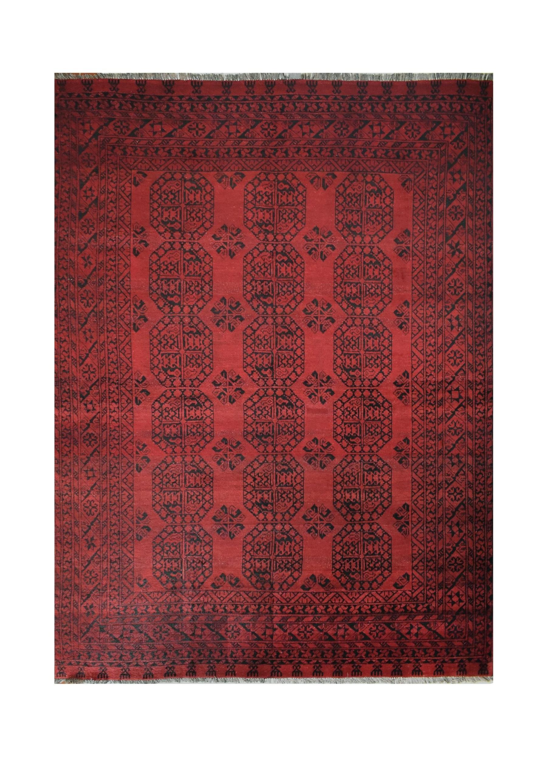 A vintage handmade Afghan Turkmen rug featuring a deep red field with repeating black octagons.